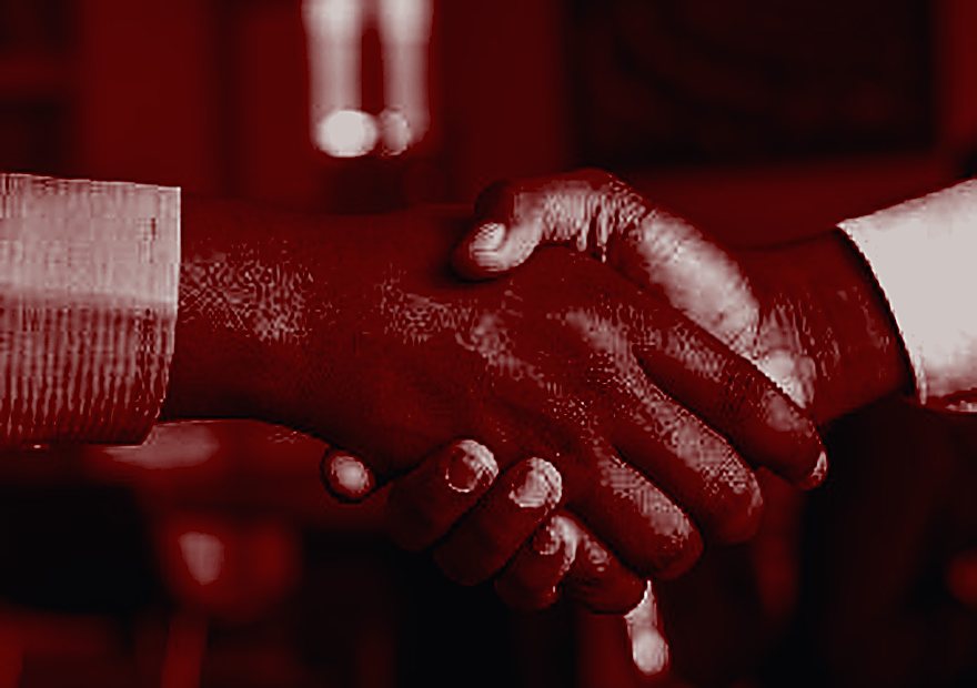 Two people shaking hands after a meeting