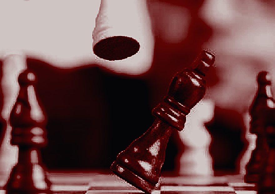 A hand moving a chess piece